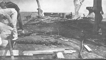 View of San Marcos (Texas), circa 1911, showing the results of target practice, on the deck, most likely from the Kansas, BB 21. The officers and crew are also most probably from the Kansas.