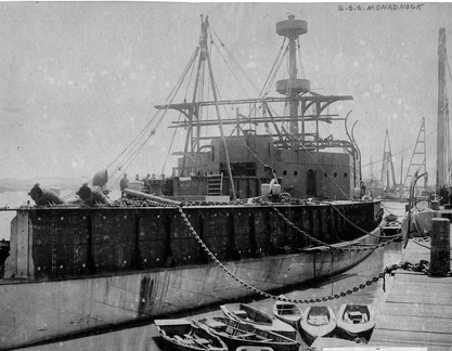 The USS Monadnock alongside the quay wall under construction at Mare Island Navy Yard in 1896.